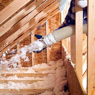 An insulation contractor spraying in insulation.